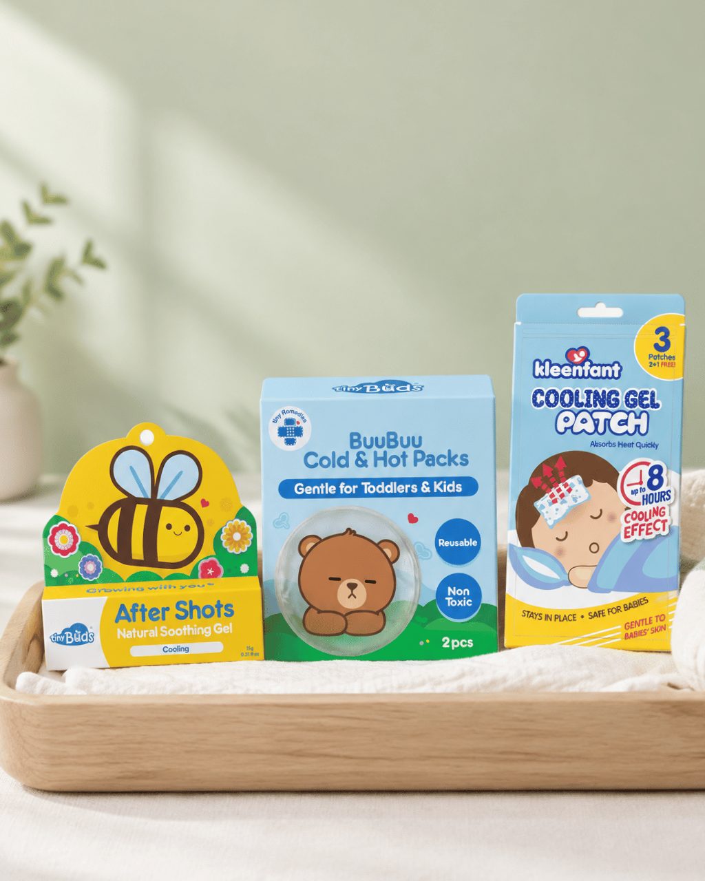 Baby remedies including soothing gel, cold and hot packs and cooling gel patches on a wooden tray