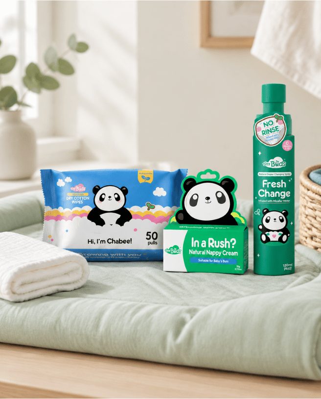 Diaper care wipes, nappy cream and changing spray on a sage changing mat
